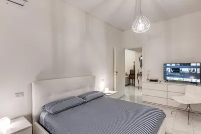 a bedroom with a bed and a flat screen tv at Nina's Apartment with terrace Rome Monteverde in Rome