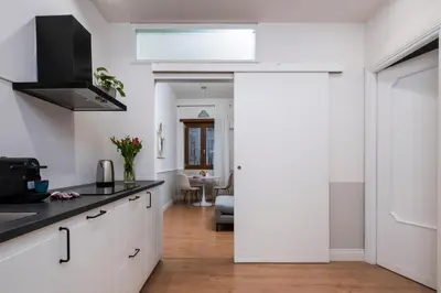 a kitchen with white cabinets and a skylight at Zen Vatican Studio - Zen 30 in Rome