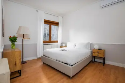 a white bedroom with a white bed and a window at Zen Vatican Studio - Zen 30 in Rome