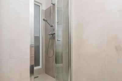 a shower with a glass door in a bathroom at Zen Vatican Studio - Zen 30 in Rome