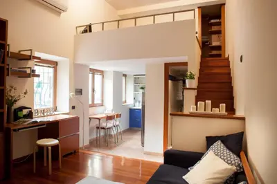 a living room and kitchen with a loft bed at Chez David in Rome
