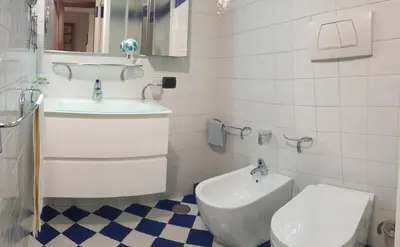 a white bathroom with a sink and a toilet at Chez David in Rome