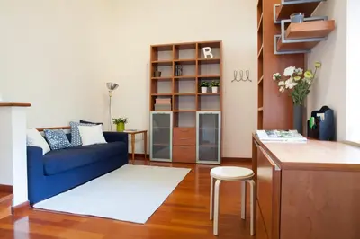 a living room with a blue couch and a table at Chez David in Rome
