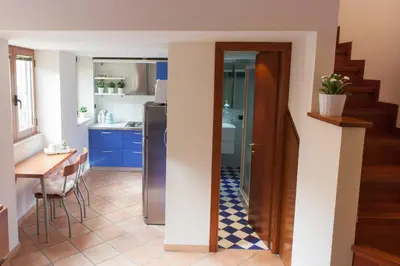 a kitchen with a stainless steel refrigerator and a table at Chez David in Rome