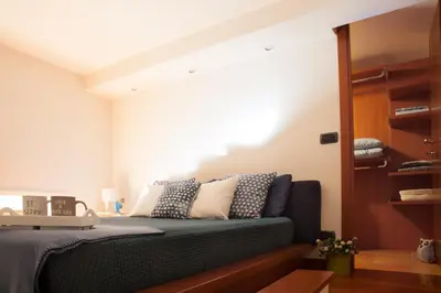a bedroom with a bed with a blue couch at Chez David in Rome