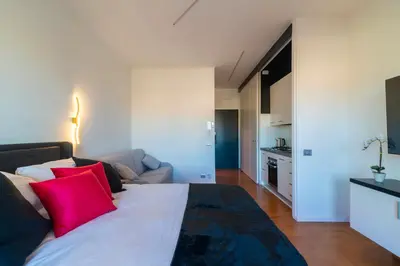 a bedroom with a large bed with red pillows at Aim - La Cupola - Saint Peter view apartment in Rome