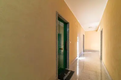 a hallway with a green door in a building at Aim - La Cupola - Saint Peter view apartment in Rome