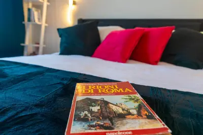 a book sitting on top of a bed at Aim - La Cupola - Saint Peter view apartment in Rome