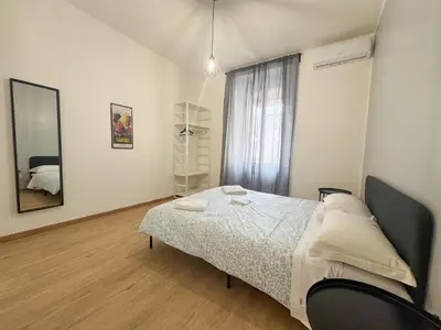 a bedroom with a bed and a large window at Mocenigo Boutique Apartment in Rome
