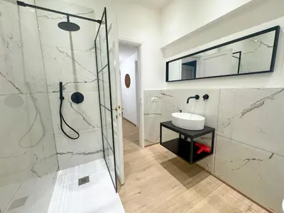 a bathroom with a shower and a sink at Mocenigo Boutique Apartment in Rome