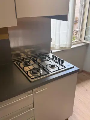 a stove top oven in a kitchen next to a window at Mocenigo Boutique Apartment in Rome