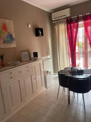 a kitchen with a table and a dining room at Casetta Maria Pia near Metro A Cornelia in Rome