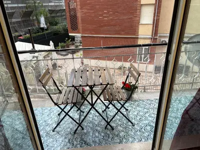a pair of chairs sitting on a balcony at Casetta Maria Pia near Metro A Cornelia in Rome