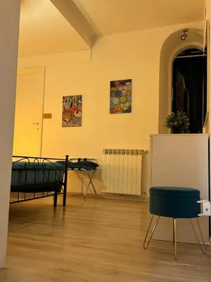 a room with a bed and a table and a chair at suite Colosseo in Rome