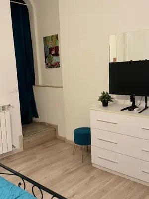a bedroom with a tv on top of a dresser at suite Colosseo in Rome
