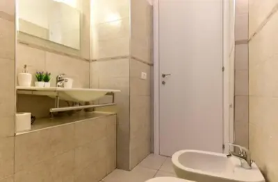 a bathroom with a sink and a toilet and a mirror at suite Colosseo in Rome