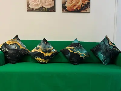a green couch with four pillows on it at suite Colosseo in Rome