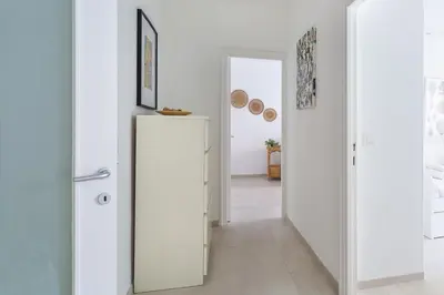 a hallway with white walls and a refrigerator at Iflat New Cozy Retreat Near the Colosseum in Rome
