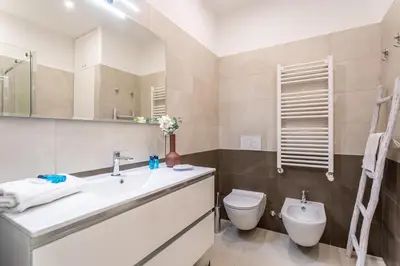 a bathroom with a sink and a toilet at Iflat New Cozy Retreat Near the Colosseum in Rome