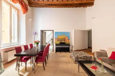 a living room with a table and a piano at Navona Stylish Apartment - Up to 5 People in Rome