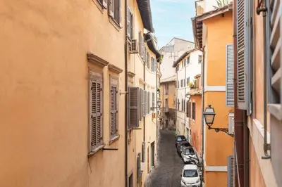 an alley with cars parked on a street between buildings at Navona Stylish Apartment - Up to 5 People in Rome