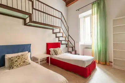 a bedroom with two beds and a staircase at Navona Stylish Apartment - Up to 5 People in Rome