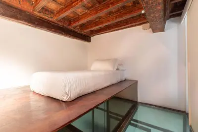 a bed in a room with a glass floor at Navona Stylish Apartment - Up to 5 People in Rome