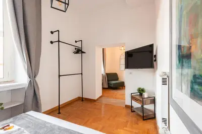 a room with a bed and a flat screen tv at Appartamento Via XXIV Maggio in Rome
