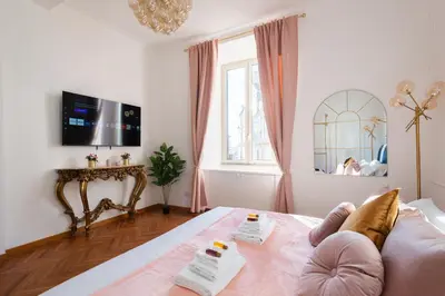 a bedroom with a bed and a tv and a window at Appartamento Via XXIV Maggio in Rome