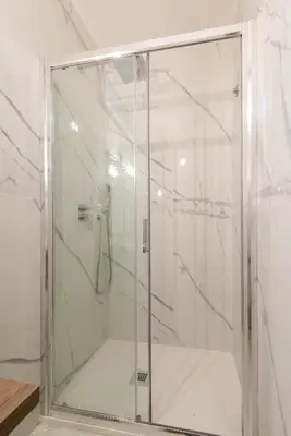 a shower with a glass door in a bathroom at Appartamento Via XXIV Maggio in Rome