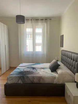 a bedroom with a large bed with a large window at Casetta via delle Cave in Rome