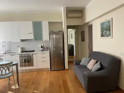 a living room with a couch and a kitchen at Casetta via delle Cave in Rome