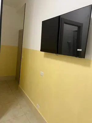 a flat screen tv on the corner of a wall at TURATI TERMINi in Rome