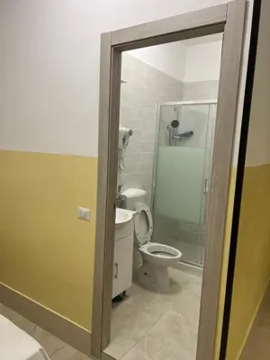 a bathroom with a toilet and a glass shower at TURATI TERMINi in Rome