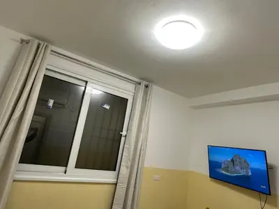 a room with a window and a television and a curtain at TURATI TERMINi in Rome