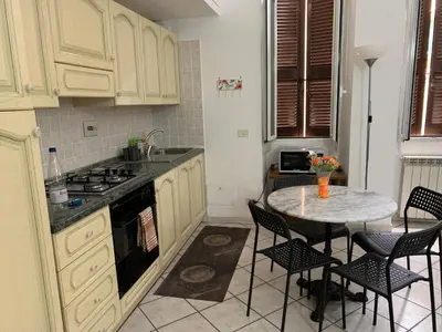 a kitchen with a table with chairs and a stove at Casa Adry in Rome