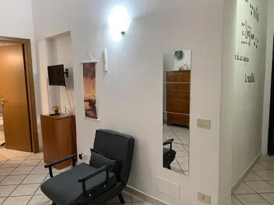 a black chair in a room with a mirror at Casa Adry in Rome