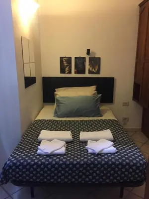 a bed with two pillows on it in a room at Casa Adry in Rome