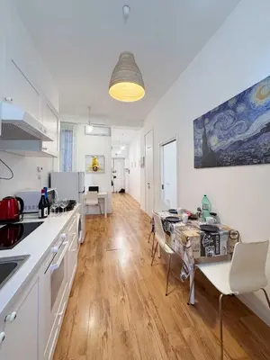 a kitchen and dining room with a table and chairs at Piramide Suites 2 Bedrooms & 2 Bathrooms in Rome
