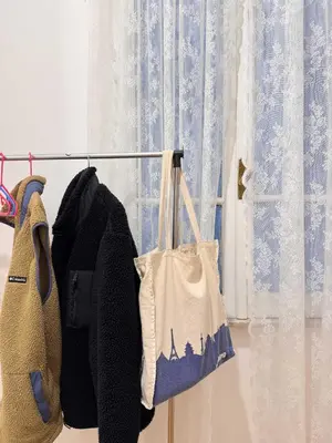 a coat and a bag on a clothes rack next to a window at Piramide Suites 2 Bedrooms & 2 Bathrooms in Rome