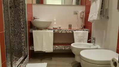a bathroom with a white toilet and a sink at Pope's bridge in Rome