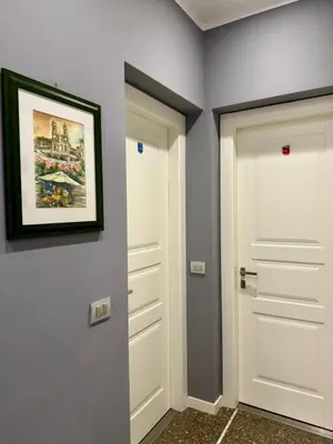 a hallway with two white doors and a picture on the wall at Pope's bridge in Rome