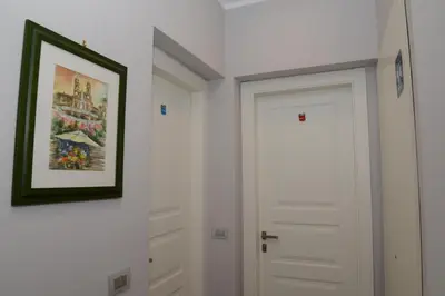 a hallway with a white door and a picture on the wall at Pope's bridge in Rome
