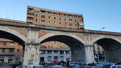 a large bridge with cars parked in a parking lot at Pope's bridge in Rome