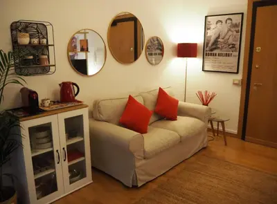 a living room with a couch and mirrors on the wall at Casa Aurelia 641 in Rome
