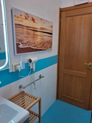 a bathroom with a sink and a wooden door at Casa Aurelia 641 in Rome