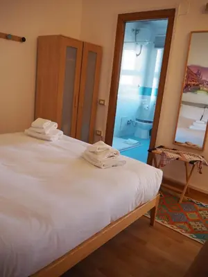 a bedroom with a white bed and a mirror at Casa Aurelia 641 in Rome