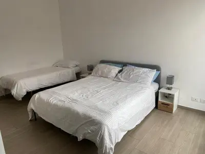 a bedroom with two beds with white sheets at Home34 in Rome