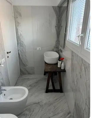 a white bathroom with a sink and a toilet at Home34 in Rome