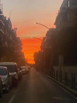a city street with a sunset in the background at Home34 in Rome